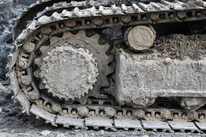 Excavator undercarriage track shoe and sprocket close-up